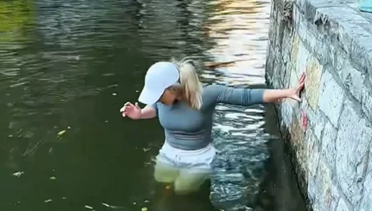 Koli basili uyarılarını umursamayan kadın telefonu için nehre girdi